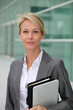 Mature businesswoman standing in front of modern building