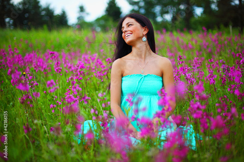 Photo: woman on summer flower field woman on summer flower field