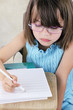 Photo: Child Sitting at School Desk With Glasses Child Sitting at School Desk With Glasses
