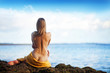 beautiful woman sitting from the back on beach, bali