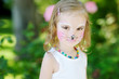 Adorable little girl with her face painted