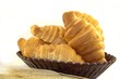 Croissants in a bread basket on white background