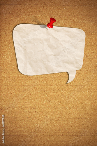 Photo: blank speech bubble note paper with push pins on cork board blank speech bubble note paper with push pins on cork board