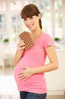 Pregnant woman eating chocolate
