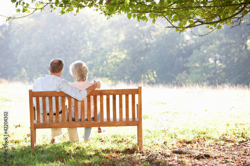 Photo: Senior couple sitting outdoors Senior couple sitting outdoors