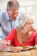 Senior man looking after sick wife