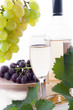 Photo: White wine bottle, glass and cask with grapes White wine bottle, glass and cask with grapes