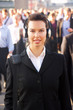 Photo: Female commuter in crowd wearing headphones Female commuter in crowd wearing headphones