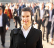 Photo: Female commuter in crowd wearing headphones Female commuter in crowd wearing headphones