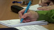 hand of a woman writes a pen in a notebook
