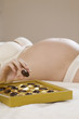 Close-up of pregnant woman's hand holding chocolate