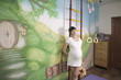 Portrait of smiling pregnant woman leaning on ladder
