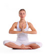 Young woman practicing yoga, sitting in a lotus position