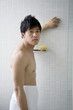 Portrait of young man wrapped in towel