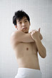 Portrait of young man in bathroom stretching