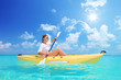 A female kayaking on a sunny day