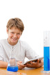 Young science student with tablet doing homework.