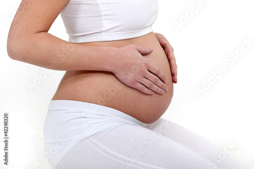 Photo: Pregnant woman touching her belly Pregnant woman touching her belly