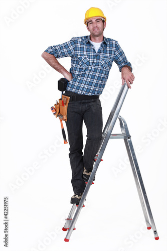 Photo: An handyman on a ladder. An handyman on a ladder.