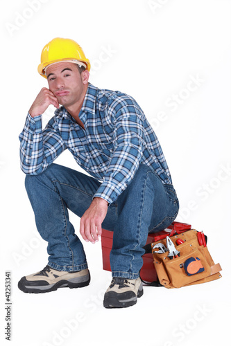 Photo: Bored builder sat on tool-box Bored builder sat on tool-box