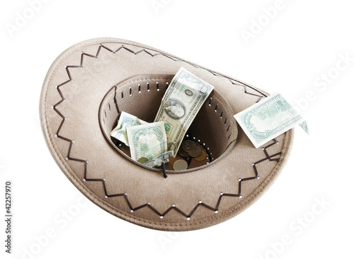 Photo: Money in a cowboy hat. Alms Money in a cowboy hat. Alms