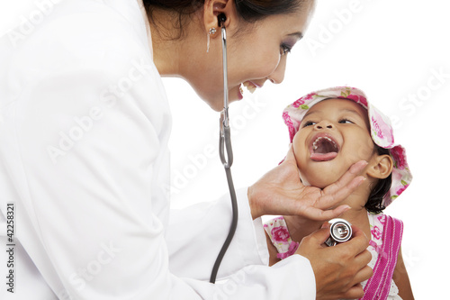 Photo: Femal doctor examining child Femal doctor examining child