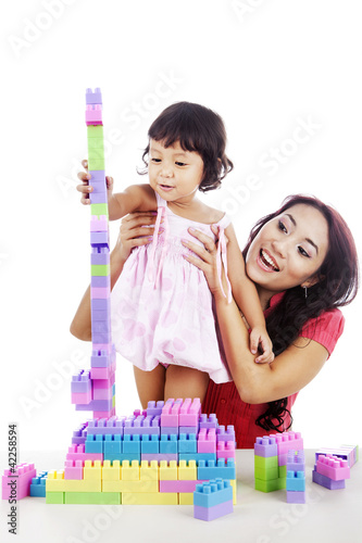 Photo: Girl with mother playing with blocks Girl with mother playing with blocks
