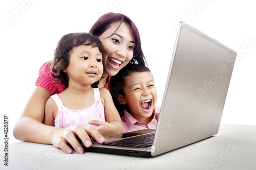 Photo: Happy family using laptop Happy family using laptop