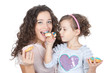 picture of happy mother and little girl with colorful donuts