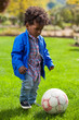 Outdoor portrait of a black baby playing soccer