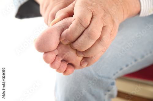 Photo: man scratching bottom of foot man scratching bottom of foot