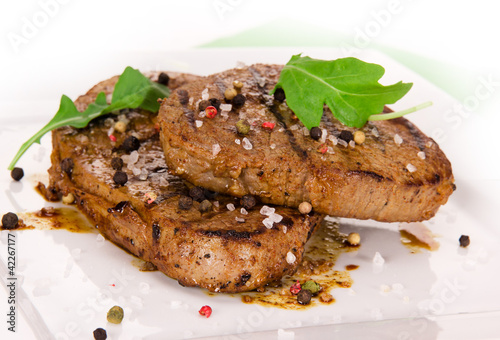 Photo: Grilled Beef Steak Isolated On a White Background Grilled Beef Steak Isolated On a White Background