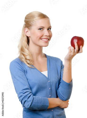 Photo: Smiling attractive woman offers a red apple, isolated Smiling attractive woman offers a red apple, isolated