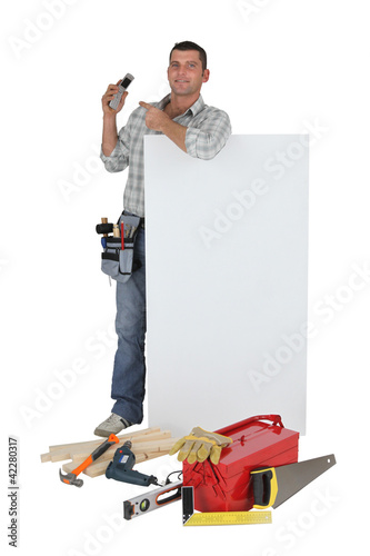 Photo: Carpenter pointing to mobile telephone Carpenter pointing to mobile telephone
