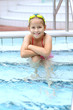 Child relaxing by swimming pool