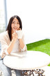 a young asian woman relaxing cafe