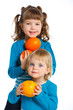 Foto: Happy girls with oranges Happy girls with oranges