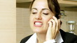 Angry beautiful businesswoman fighting talking on the phone