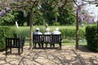 elderly sitting relaxing on a bench in front of water