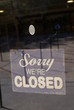 Photo: sign. sorry we're closed sign. sign on a glass door sign. sorry we're closed sign. sign on a glass door
