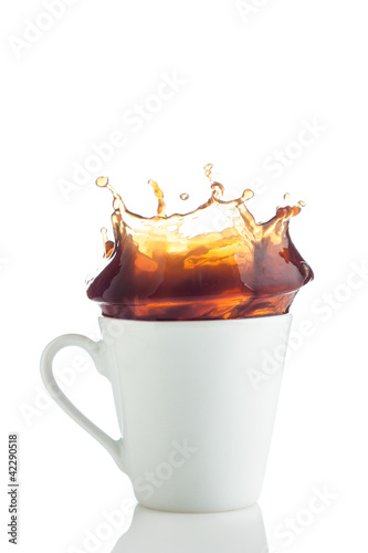 Photo: Splash of coffee in white cup Splash of coffee in white cup