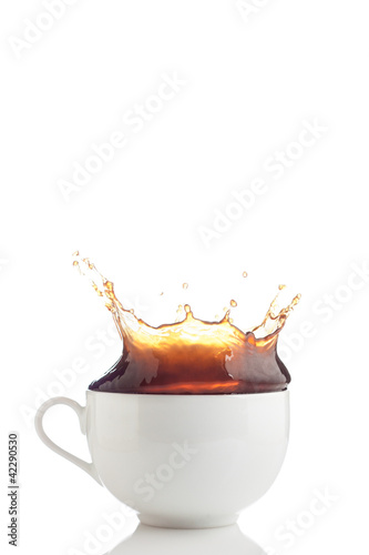 Photo: Splash of coffee in white cup Splash of coffee in white cup