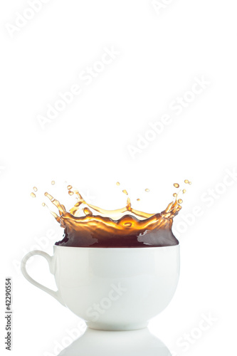Photo: Splash of coffee in white cup Splash of coffee in white cup