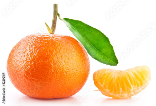 Photo: Tangerine and its slice on white background. Tangerine and its slice on white background.