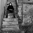 masked figure with doll hand