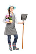 Foto: Full length portrait of a female worker holding a shovel Full length portrait of a female worker holding a shovel
