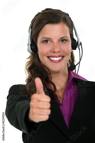 Foto: Brunette call-center worker giving the thumbs-up Brunette call-center worker giving the thumbs-up
