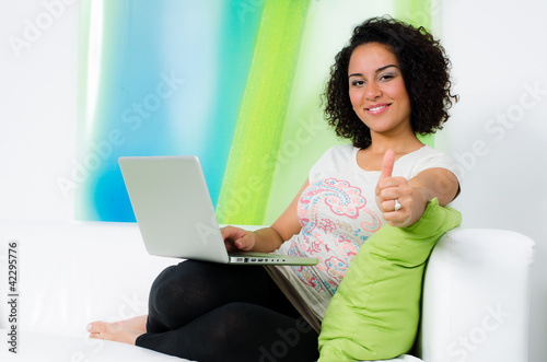Photo: studentin mit notebook zeigt daumen hoch studentin mit notebook zeigt daumen hoch
