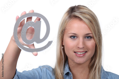 Photo: Blond teenager holding metal symbol Blond teenager holding metal symbol