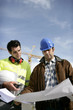 Tradesman and an engineer examining a blueprint